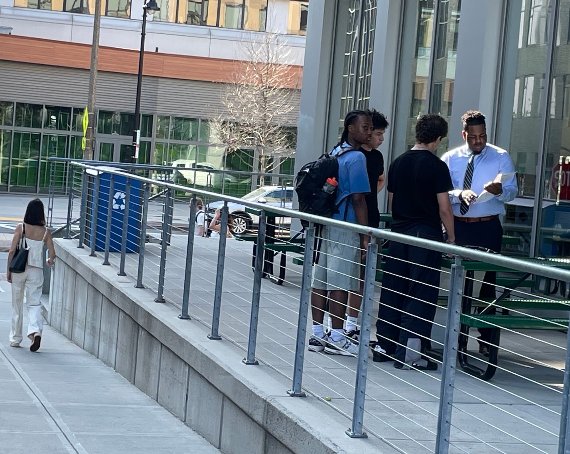 At-large Councilor Henry Santana meets with three volunteers outside the Whole Foods in the South End Sunday.