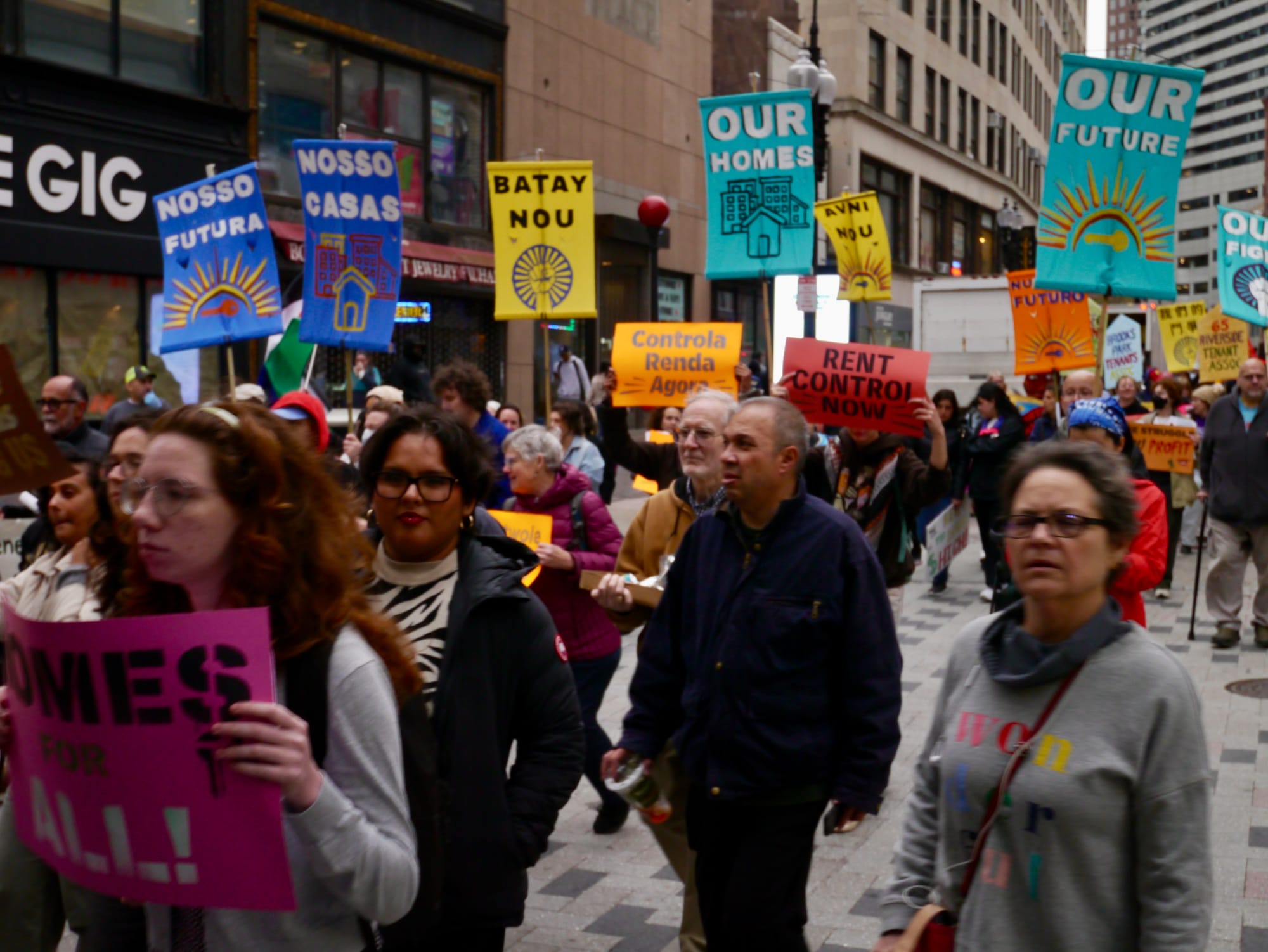 Housing activists march with signs calling for rent control on Washington Street in the Downtown Crossing area.