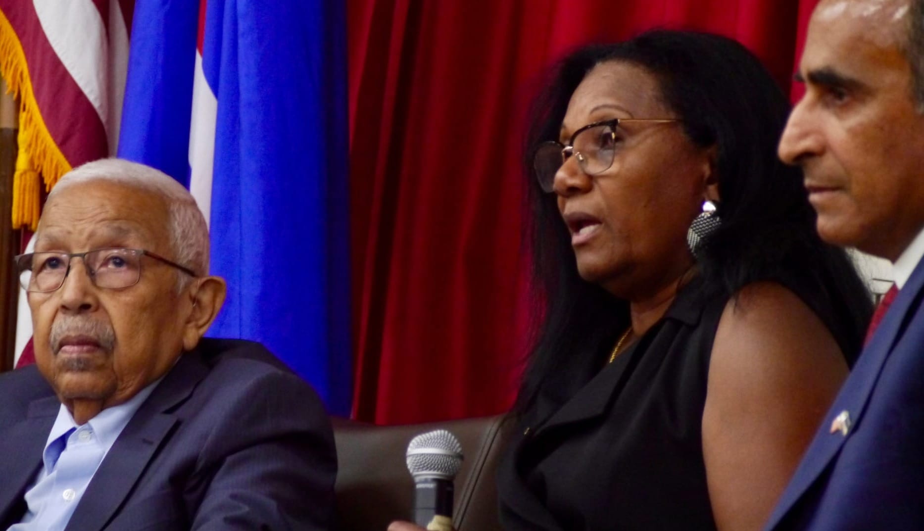 Gunga Tavares holds microphone while translating for former Cape Verdean President Pedro Pires.