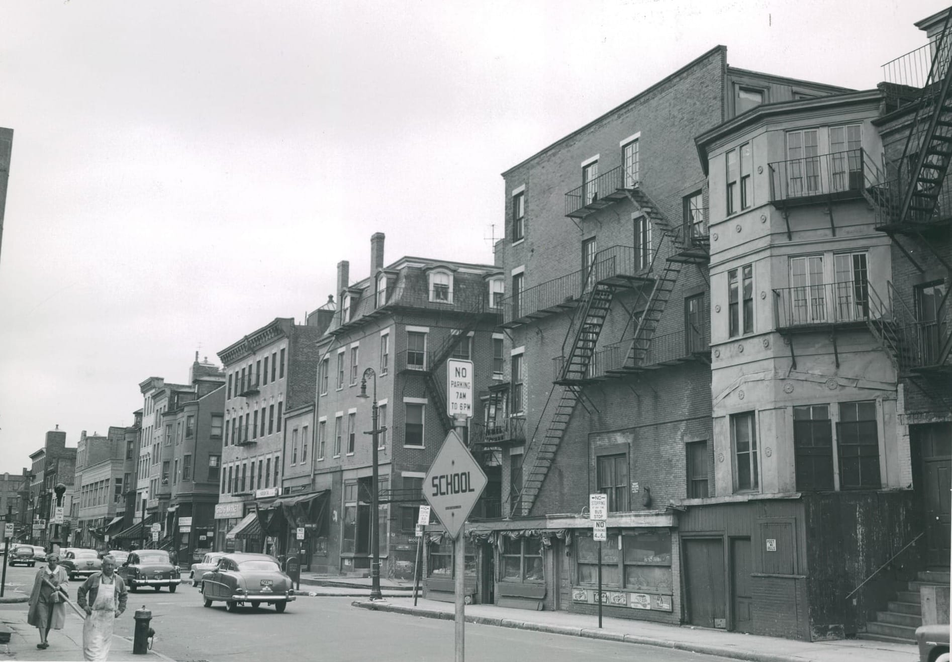 City of Boston photo archive image shows Harrison Avenue from the corner of Oswego Street in the New York Streets area of the South End. All buildings shown here were demolished in the city's first urban renewal project.