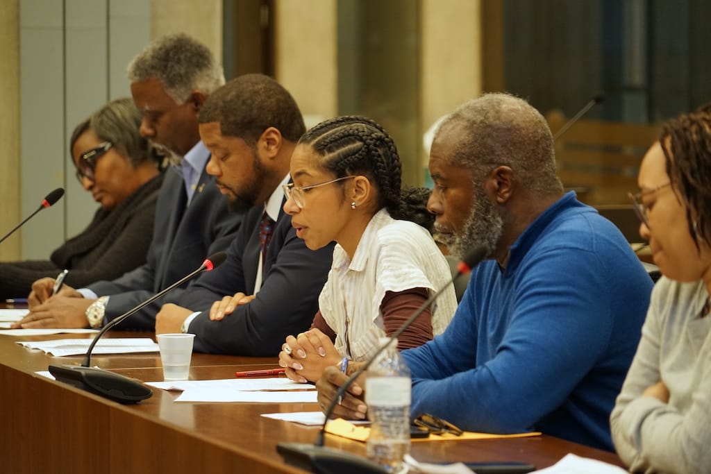 Seated with other community members, Franklin Park abutter Priscilla Andrade testifies during a City Council hearing on the leasing of White Stadium to a women’s professional soccer team. 