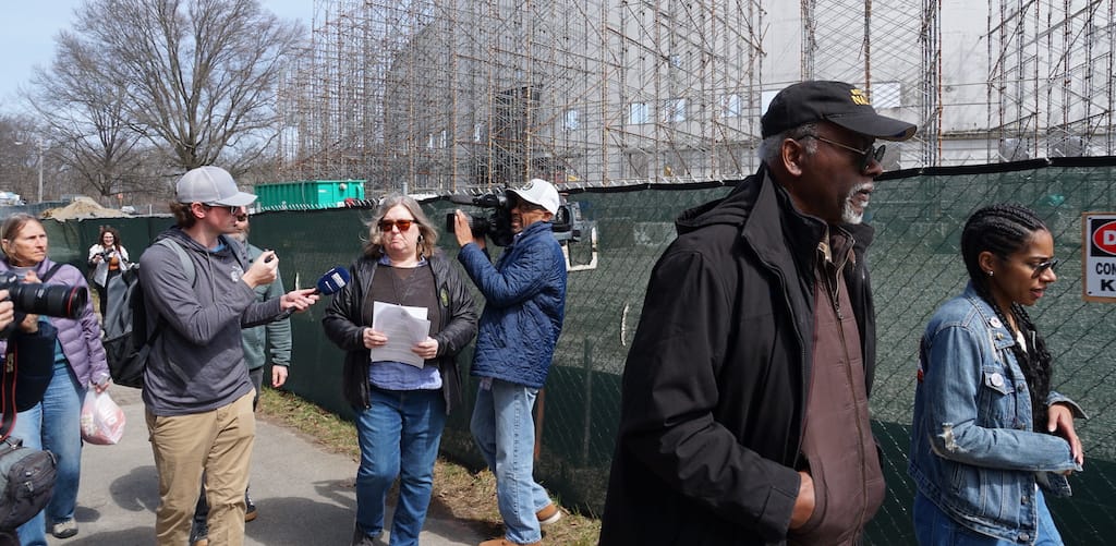 Franklin Park Defenders Louis Elisa and Patricia Andrade lead a tour of the area around White Stadium while Melissa Hamel talks to reporters.