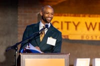 826 Boston Executive Director Corey Yarbrough speaks at a podium at City Winery.