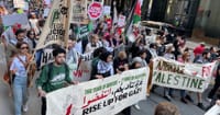 Demonstrators march on Congress Street in downtown Boston.