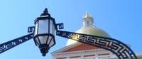 The State House dome and a lamp that hangs over the building's front gate.