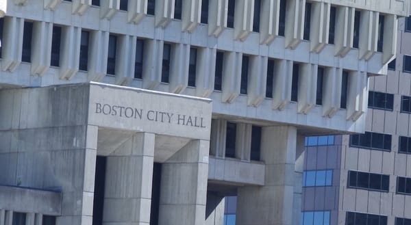 Image is a closeup of the exterior of Boston City Hall.