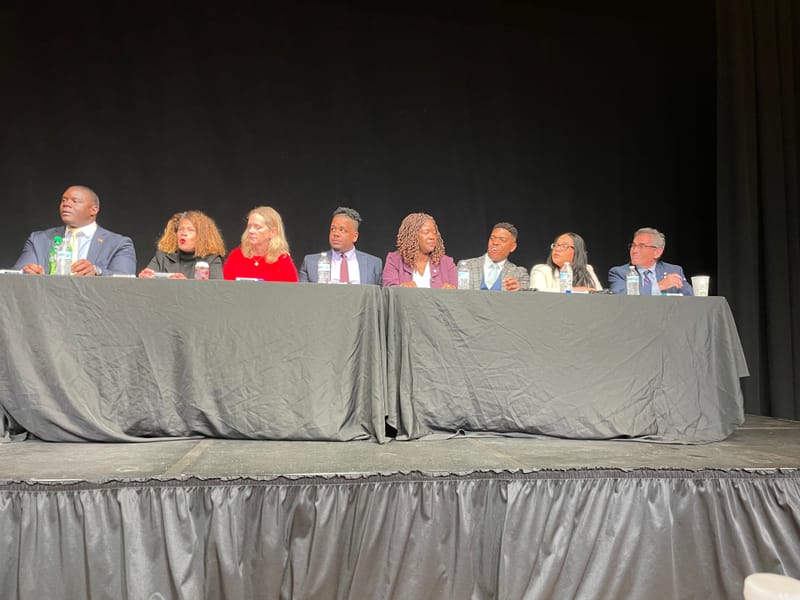 At-large candidates seated on the stage at Hibernian Hall: Will Onuoha, Julia Mejia, Erin Murphy, Henry Santana, Ruthzee Louijeune, Marvin Mathalier, Alexandra Valdez and Frank Baker.